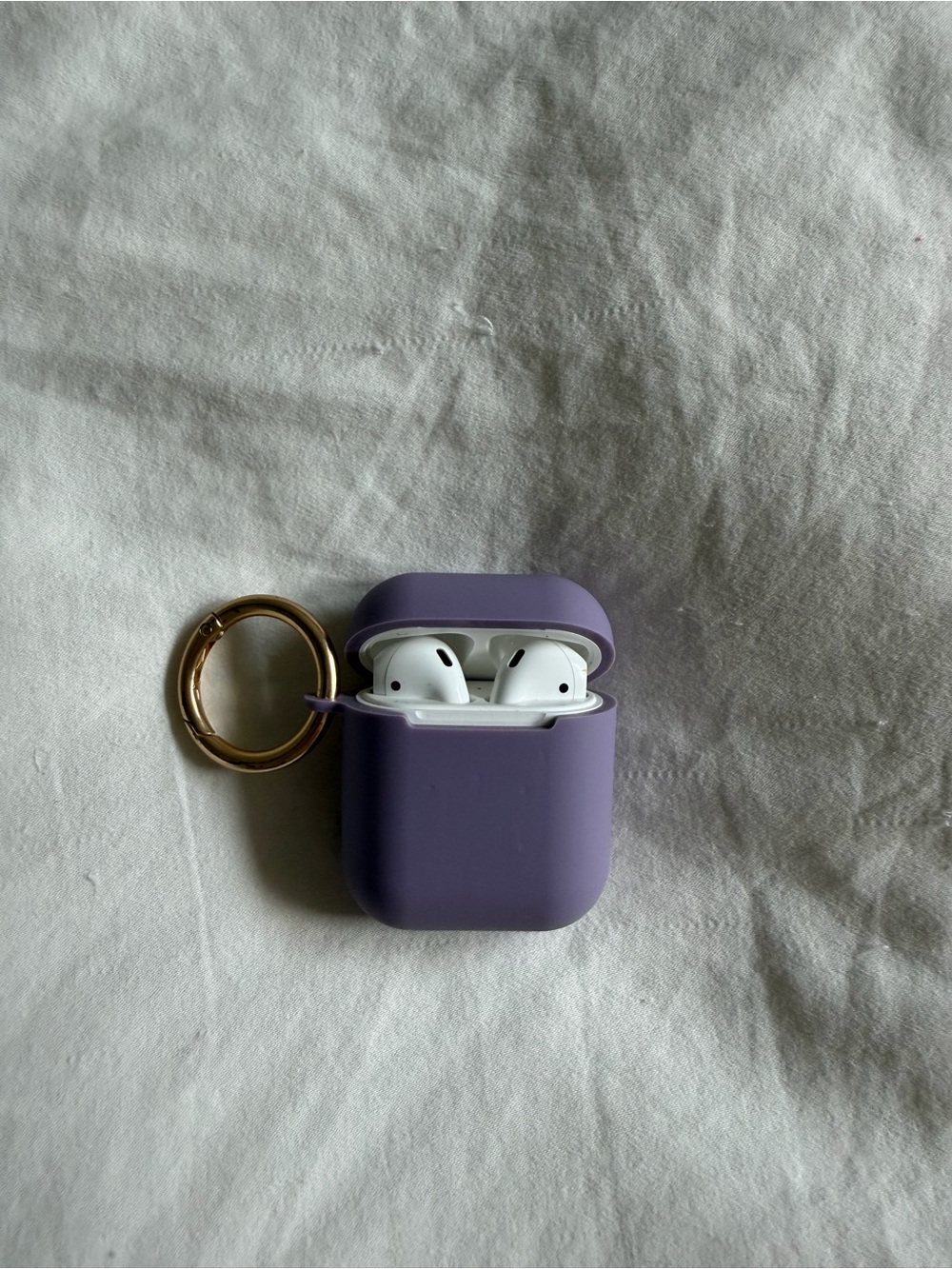 AirPods in Purple Silicone Case with Gold Keyring